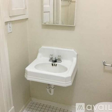 A white sink in a small bathroom.