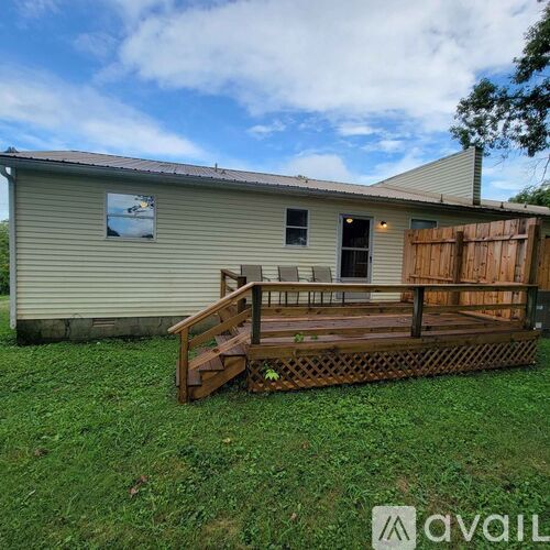 A house with a wooden deck in front.