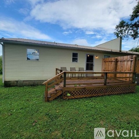 A house with a wooden deck in front.