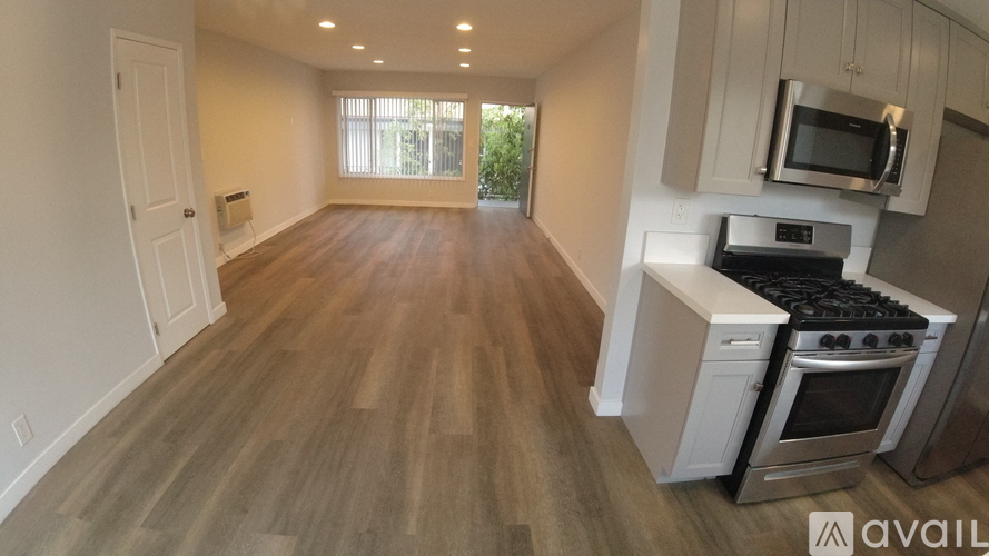 A kitchen with a stove, oven, and microwave.