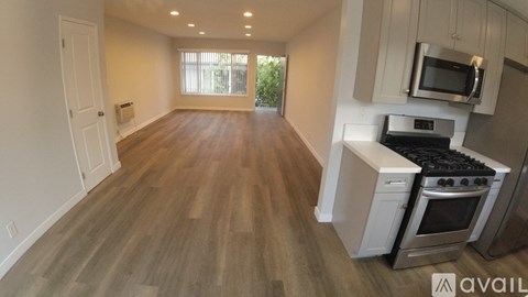 A kitchen with a stove, oven, and microwave.