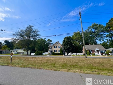 A street view with houses and a clear sky.