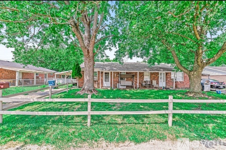 A house with a white picket fence in front of it.