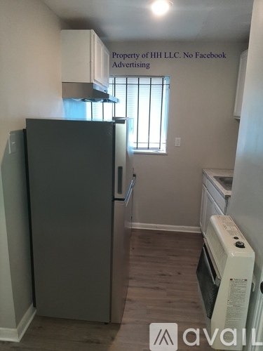 A small kitchen with a refrigerator and an oven.