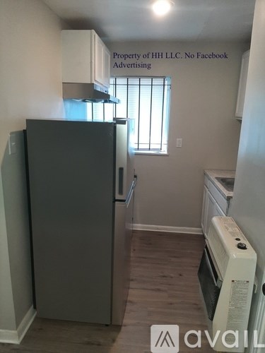 A small kitchen with a refrigerator and an oven.