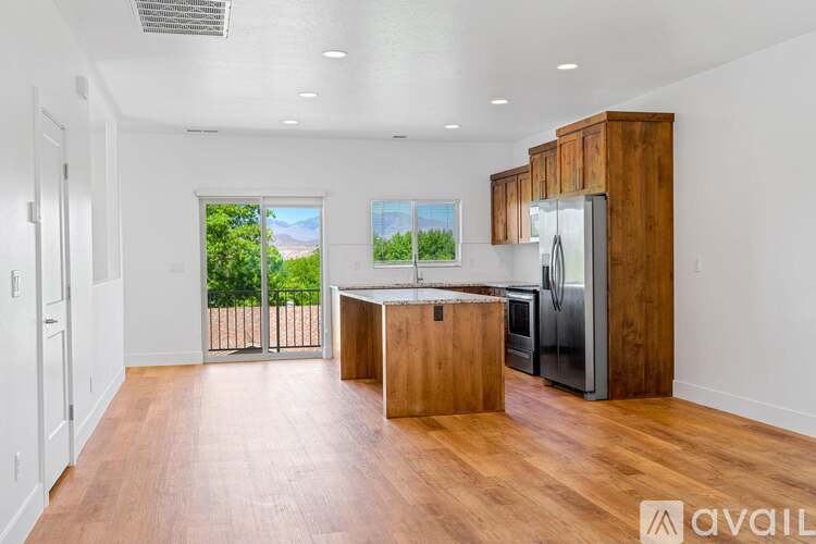 A kitchen with wooden cabinets and a refrigerator is available for rent.
