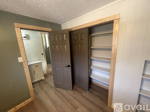 A room with a grey door and a white cabinet.