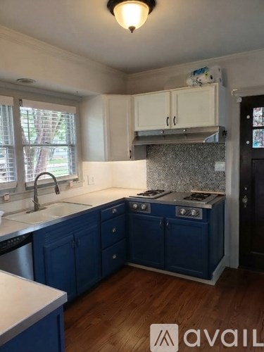 A kitchen with blue cabinets and a white countertop.