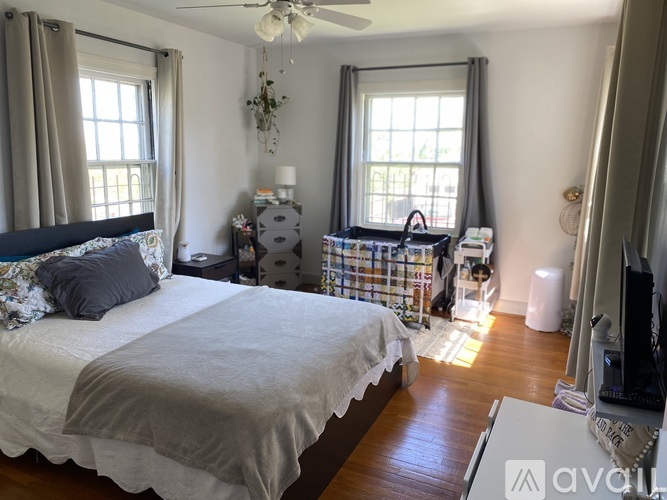 A bedroom with a large bed and a ceiling fan.
