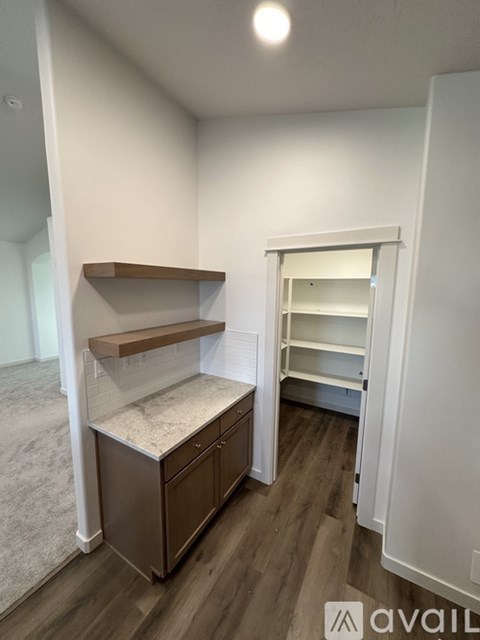A room with a cabinet and shelves in it.