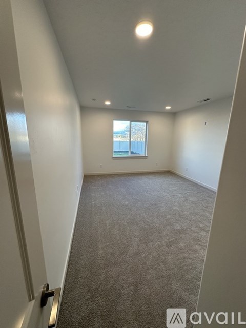 A room with carpeted floor and a window.