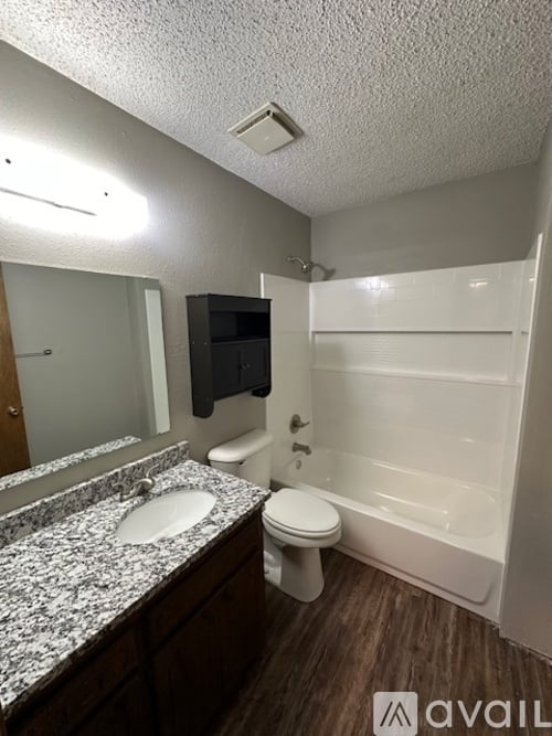 A bathroom with a toilet, sink, and bathtub.