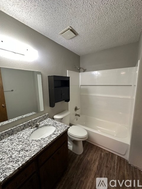 A bathroom with a toilet, sink, and bathtub.