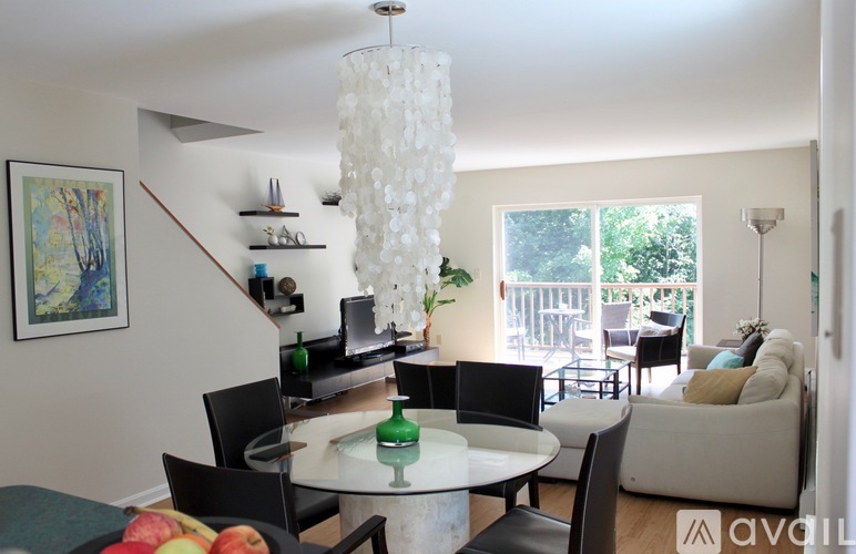 A living room with a white table and chairs.