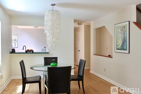 A dining room with a glass table and chairs.