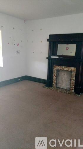 A room with a fireplace and wall decorations.