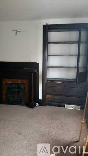 A room with a fireplace and a window.