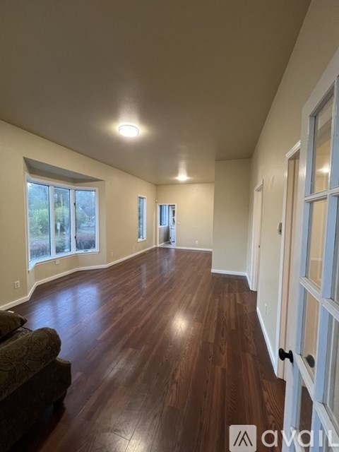 A living room with wood floors and a couch.