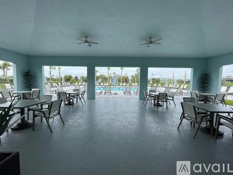 A spacious outdoor dining area with multiple tables and chairs.