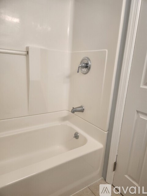 A white bathroom with a tub and a shower.
