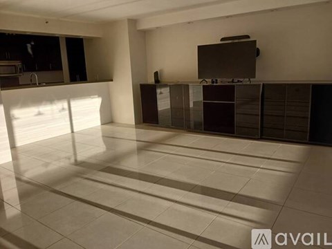 A spacious room with a television on top of a cabinet.