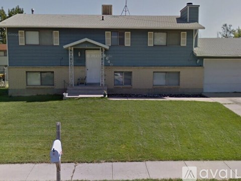 A house with a blue exterior and a white door is shown.