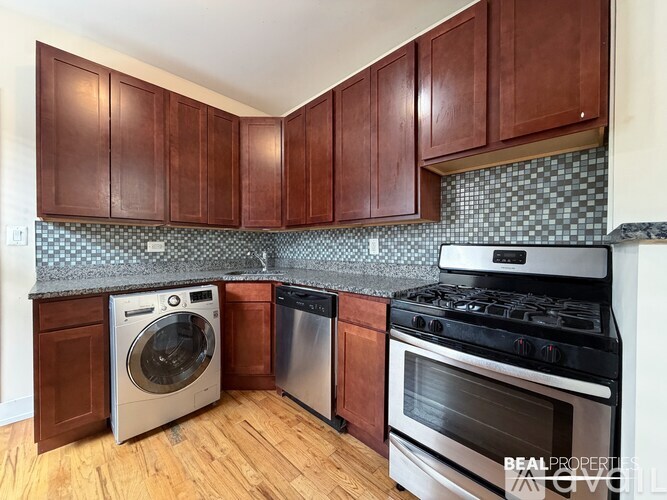 A kitchen with wooden cabinets and a black stove top oven.