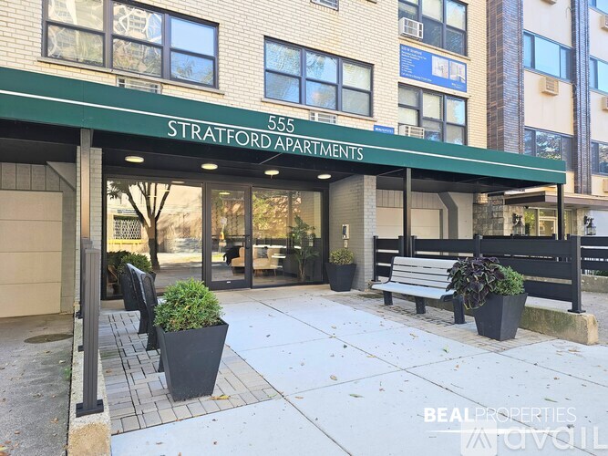 The front of a building with the name Stratford Apartments on it.
