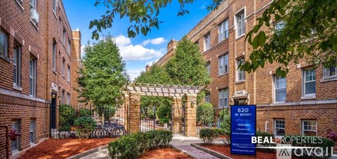 A brick building with a sign that says "620" and "BEAL PROPERTIES" in front of it.