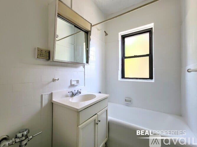 A bathroom with a sink, mirror, and toiletries.