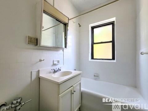 A bathroom with a sink, mirror, and toiletries.