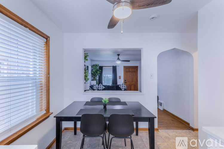 A dining room with a table and chairs.