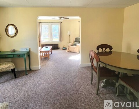 A room with a desk, chair, and bed.