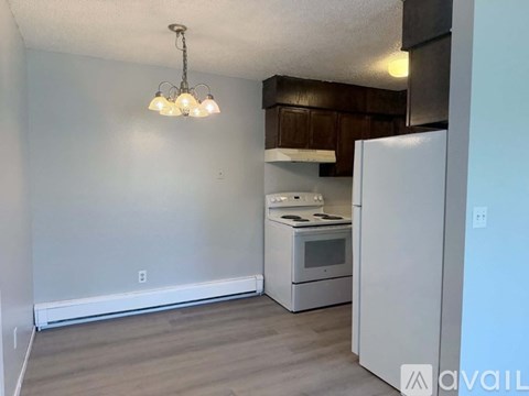 A kitchen area with a refrigerator, stove, and microwave.