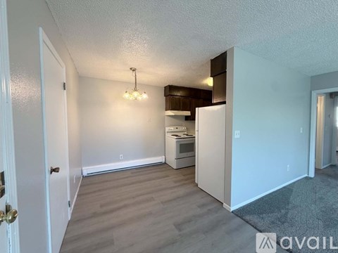 A well-lit kitchen area with a refrigerator, microwave, and oven.