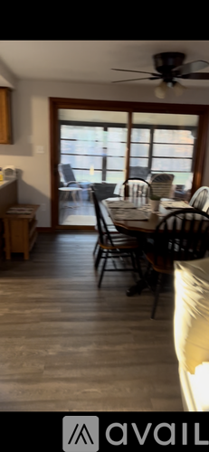 A dining room with a table set for four.
