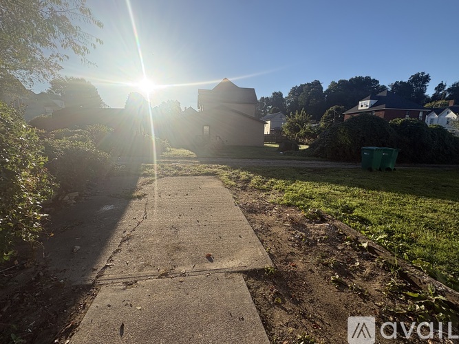 A sunny day in a residential area with a clear blue sky.