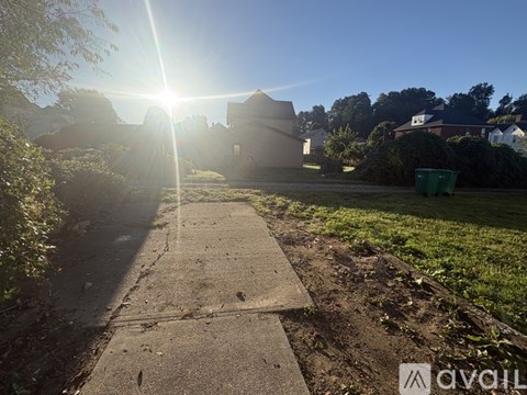 A sunny day in a residential area with a clear blue sky.