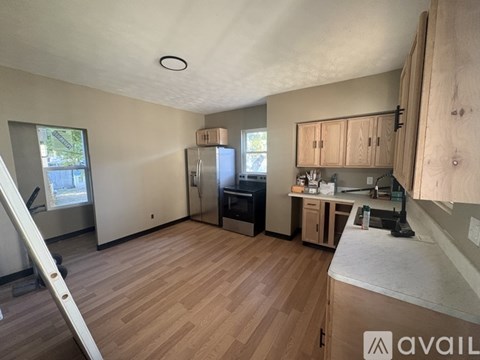 A kitchen area with wooden floors and a countertop.