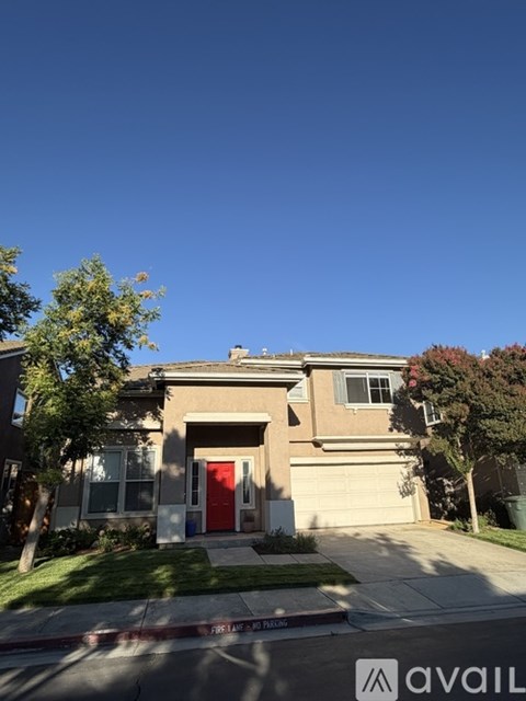 A house with a red door is for sale.