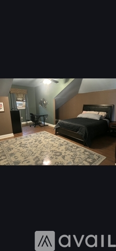 A bedroom with a bed, dresser, and mirror.