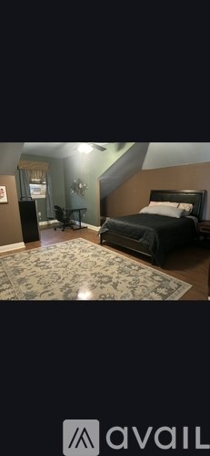 A bedroom with a bed, dresser, and mirror.
