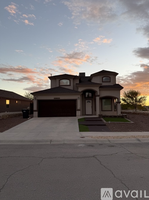 A house with a driveway in front of it.