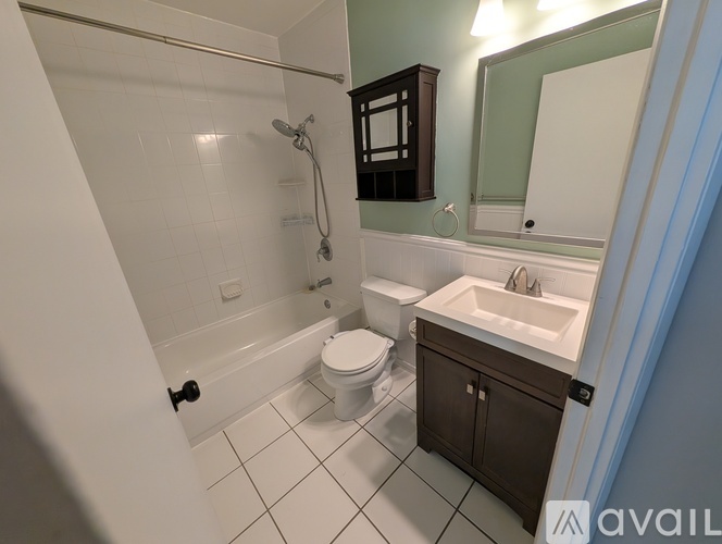 A bathroom with a white toilet, a white sink, and a white bathtub.