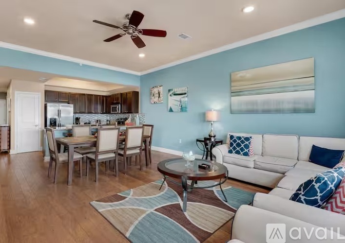 A living room with a dining table and chairs.