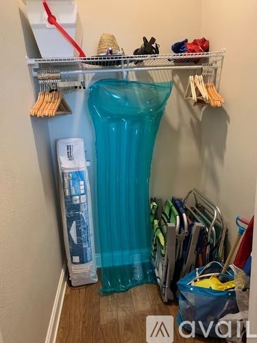 A blue laundry bag is on the floor next to a laundry basket.