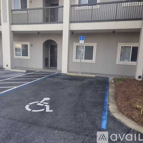 A parking space with a wheelchair symbol is painted on the pavement.