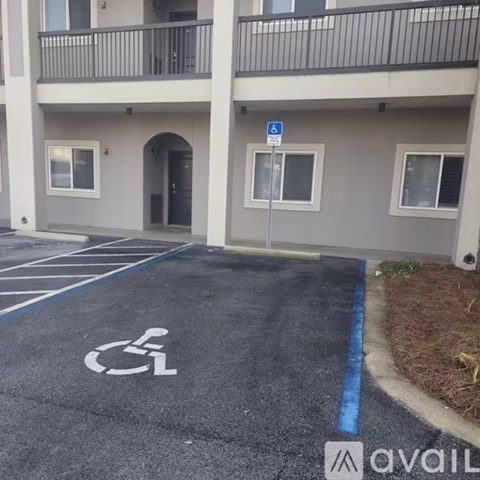 A parking space with a wheelchair symbol is painted on the pavement.