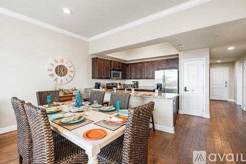 A dining room with a table set for a meal.