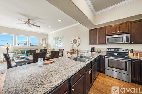 A kitchen with granite countertops and stainless steel appliances is available for rent.